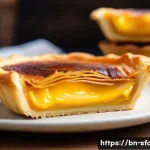 Home 12 홍콩 에그타르트 전통 방식 - A close-up view of a traditional Hong Kong egg tart on a rustic wooden plate, featuring multiple del...